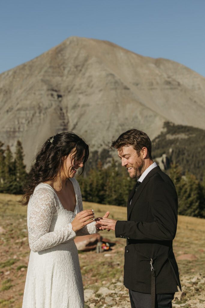 Eloping couple exchanges rings during there private ceremony at West Spanish Peak.