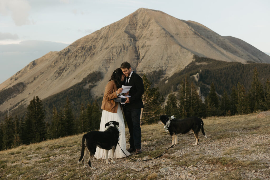 A bride rests her head on a grooms shoulder during a quiet moment on their elopement day in the mountains of Colorado.